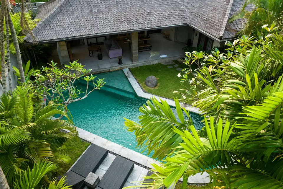 Private villa pool surrounded by tropical garden in Bali