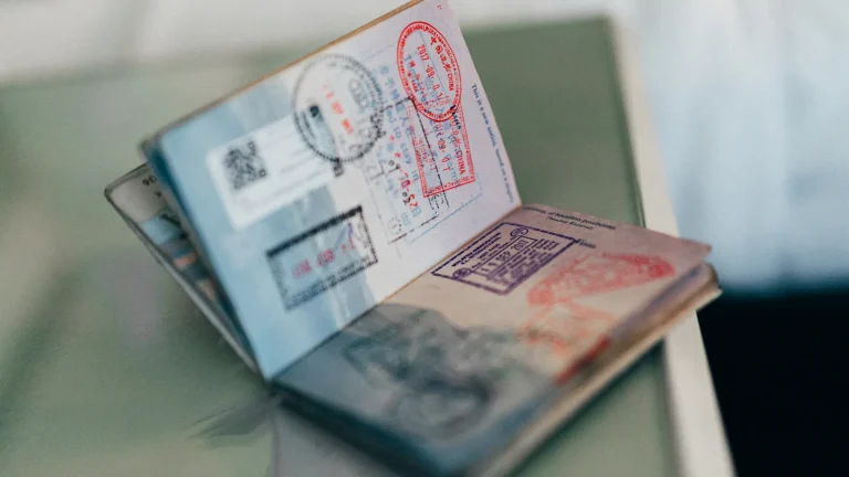 Open passport with several colourful entry stamps