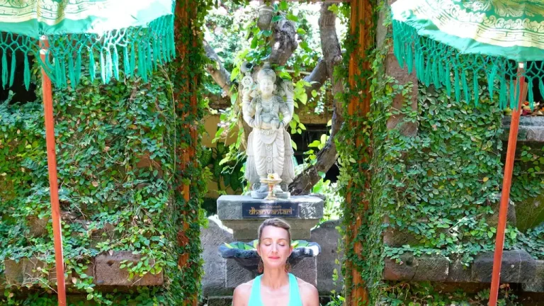 Woman practising yoga in a tropical garden in Bali