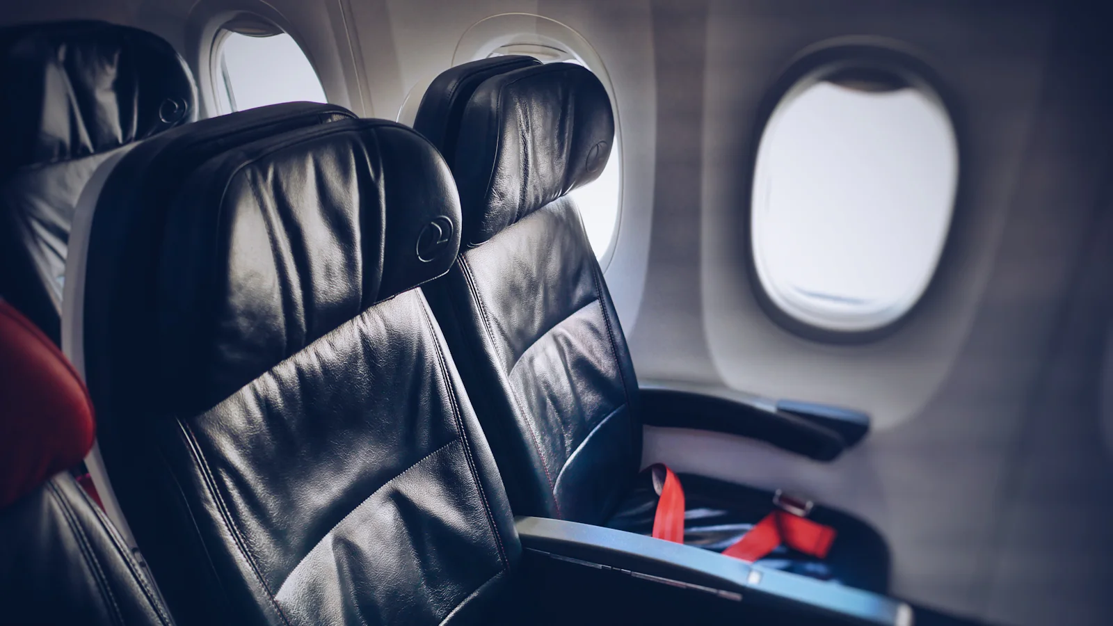 Rows of airline seats inside an aeroplane cabin