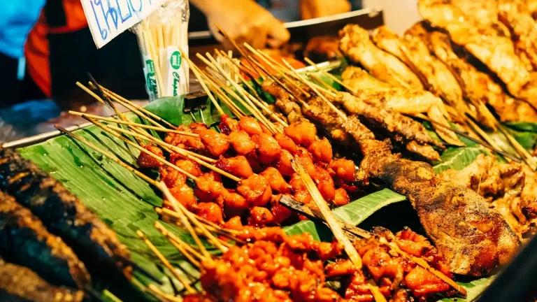 Satay skewers on display at a street food stall