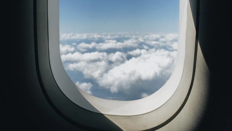 Aeroplane window looking out over the clouds