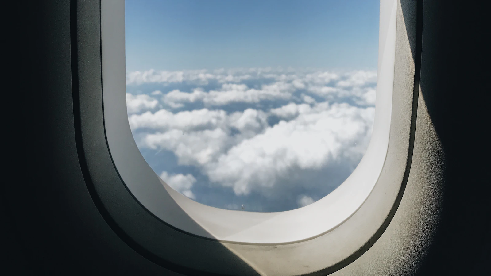 Aeroplane window looking out over the clouds