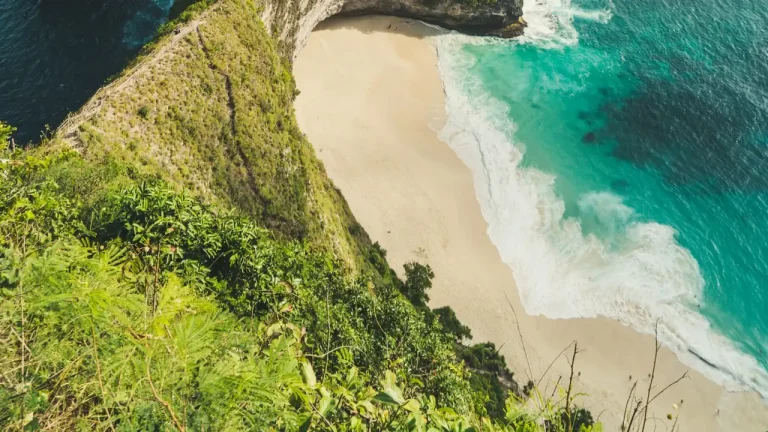 Rock formation beside the ocean under white clouds on Nusa Penida
