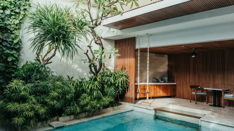 Villa swimming pool with a table and chairs beside it